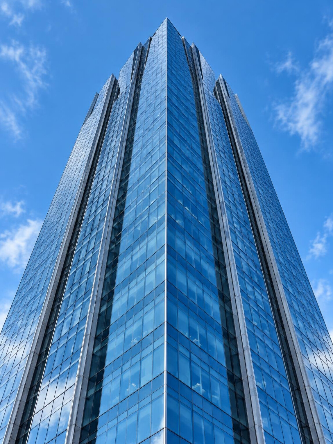 Tall glass office building seen from below