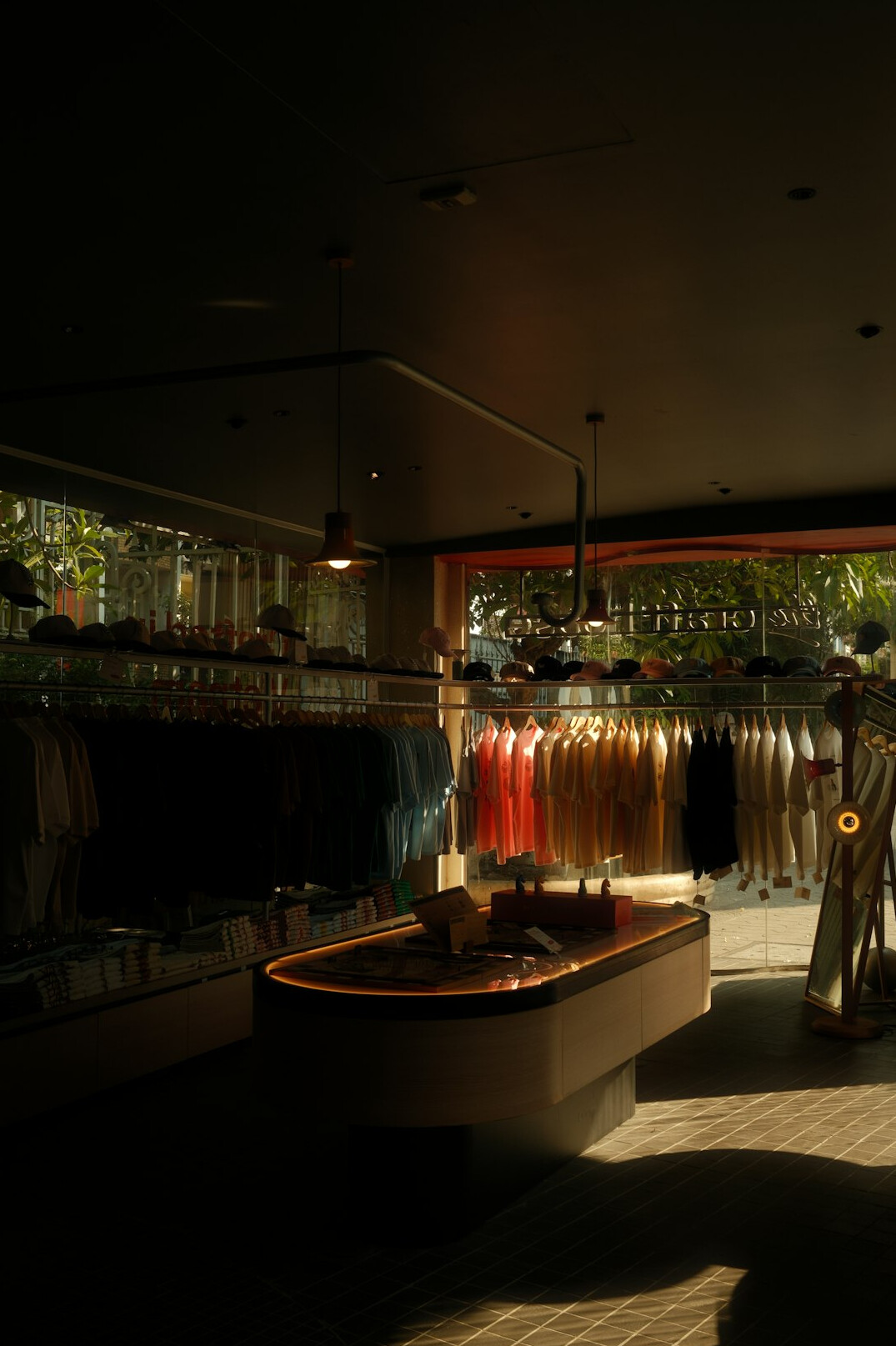 Clothing boutique with racks and warm lighting